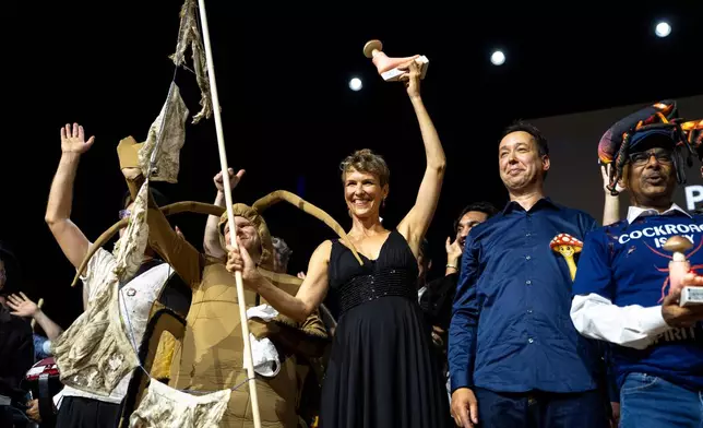 From left, Atlant Bieri, Pia Viviani and Marcel van der Heijden pose with the trophy during the Ig Nobel Prize ceremony held in the Zurich Convention Center in Zurich, Switzerland, on Thursday, Sept. 3, 2026. (Claudio Thoma/Keystone via AP)