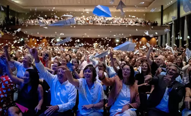 Spectators throw paper planes during the Ig Nobel Prize ceremony held in the Zurich Convention Center in Zurich, Switzerland, on Thursday, Sept. 3, 2026. (Claudio Thoma/Keystone via AP)