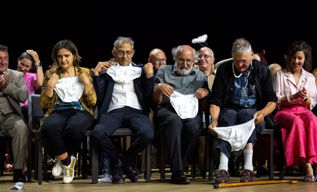 From left, Nobel Prize winners Esther Duflo, Abhijit Banerjee, Michel Mayor and Tim Hunt look at underwear handed over by the Soil Science Award Winners during the Ig Nobel Prize ceremony held in the Zurich Convention Center in Zurich, Switzerland, on Thursday, Sept. 3, 2026. (Claudio Thoma/Keystone via AP)