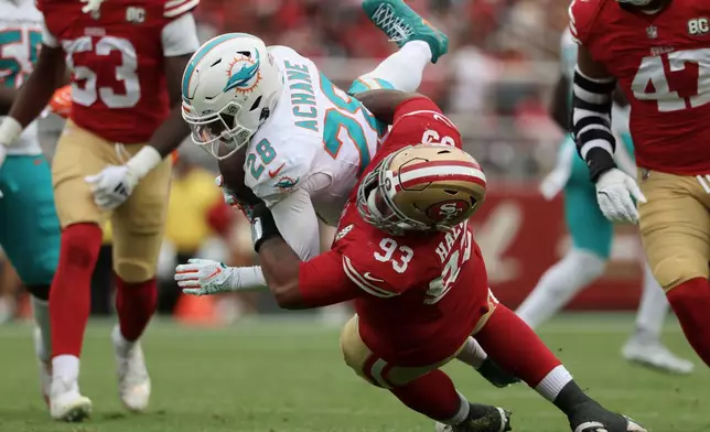 San Francisco 49ers defensive tackle Gracen Halton (93) tackles Miami Dolphins running back De'Von Achane (28) during the second half of an NFL football game in Santa Clara, Calif., Sunday, Sept. 20, 2026. (AP Photo/Jed Jacobsohn)