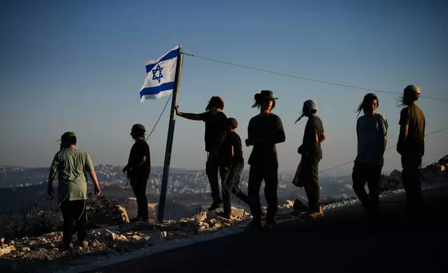 Israeli settlers gather to celebrate the inauguration of a newly built synagogue at the occupied West Bank outpost of Homesh, Wednesday, Sept. 16, 2026. (AP Photo/Ohad Zwigenberg)