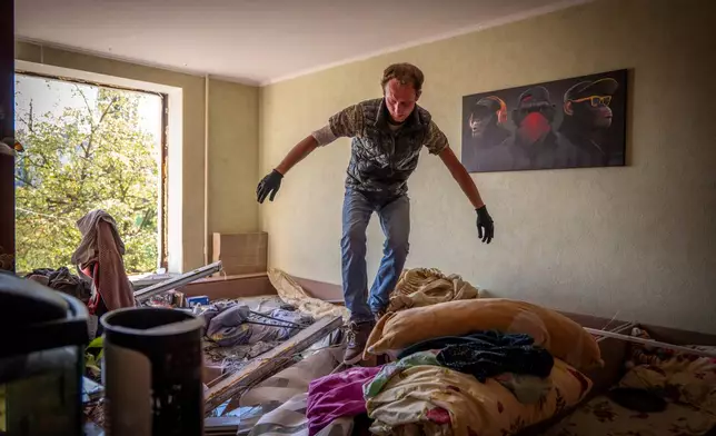 A man inspects damage to his apartment after a Russian missile exploded near his home in Kyiv, Ukraine, Thursday, Sept. 17, 2026. (AP Photo/Dan Bashakov)