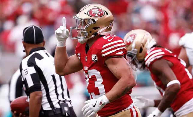 San Francisco 49ers running back Christian McCaffrey celebrates after scoring against the Miami Dolphins during the first half of an NFL football game in Santa Clara, Calif., Sunday, Sept. 20, 2026. (AP Photo/Kelley L. Cox)