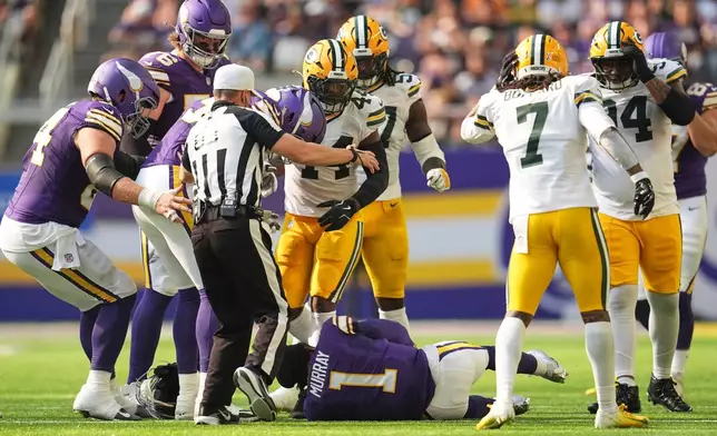 Minnesota Vikings and Green Bay Packers players look on after Vikings quarterback Kyler Murray was tackled during the first half of an NFL football game, Sunday, Sept. 13, 2026, in Minneapolis, Minn. (AP Photo/Abbie Parr)