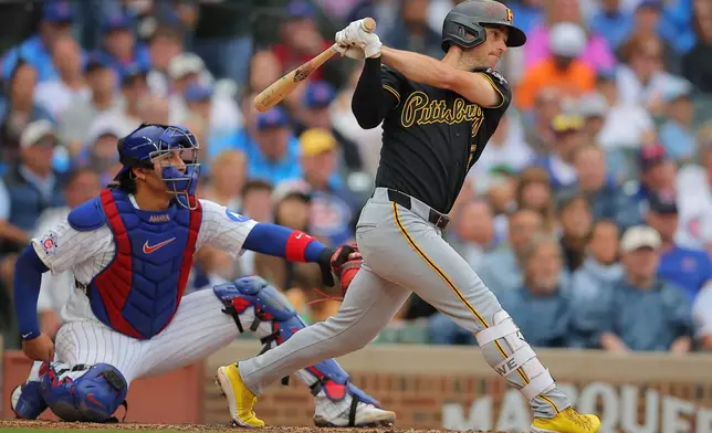 Pittsburgh Pirates' Brandon Lowe, right, watches his two-RBI single hit during the sixth inning of a baseball game against the Chicago Cubs, Sunday, Sept. 13, 2026, in Chicago. (AP Photo/Melissa Tamez)