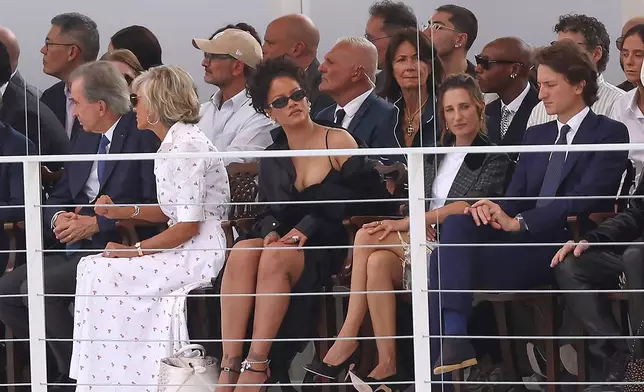 Rihanna, centre, and Camille Cottin, centre right, watch the Christian Dior Womenswear Spring Summer 2027 collection presented in Paris, France, Tuesday, Sept. 29, 2026. (AP Photo/Thomas Padilla)