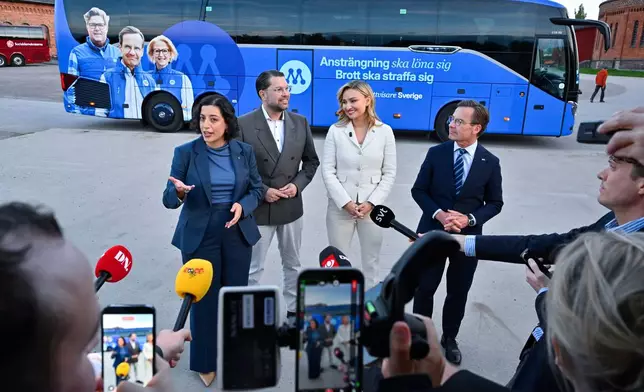 From left, the Liberals' Simona Mohamsson, Sweden Democrats' Jimmie Åkesson, Christian Democrats' Ebba Busch and Moderates' leader Prime Minister Ulf Kristersson arrive on the Moderates' bus for the party leadership televised debate in Gävle, Sweden, on Friday, Sept. 11, 2026. (Anders Wiklund/TT News Agency via AP)