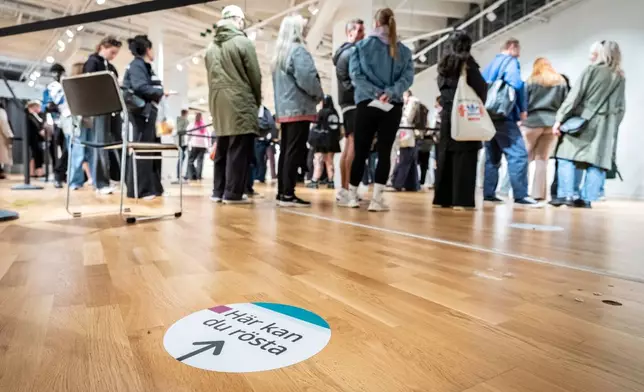People wait in line at a polling station in Triangeln shopping center Friday evening to give their early vote, in Malmo, Sweden Friday, Sept. 11, 2026, ahead of general elections on Sunday (Johan Nilsson/TT via AP)