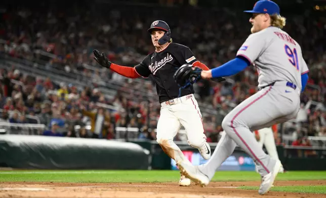 Washington Nationals' Brady House, left, comes in to score on a wild pitch by New York Mets pitcher Jonathan Pintaro, right, during the third inning of a baseball game, Friday, Sept. 25, 2026, in Washington. (AP Photo/Nick Wass)