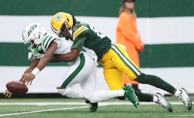 New York Jets wide receiver Isaiah Williams (18) is tackled by Green Bay Packers wide receiver J. Michael Sturdivant (87) during an NFL football game in East Rutherford, N.J., Sunday, Sept. 20, 2026. (AP Photo/Adam Hunger)