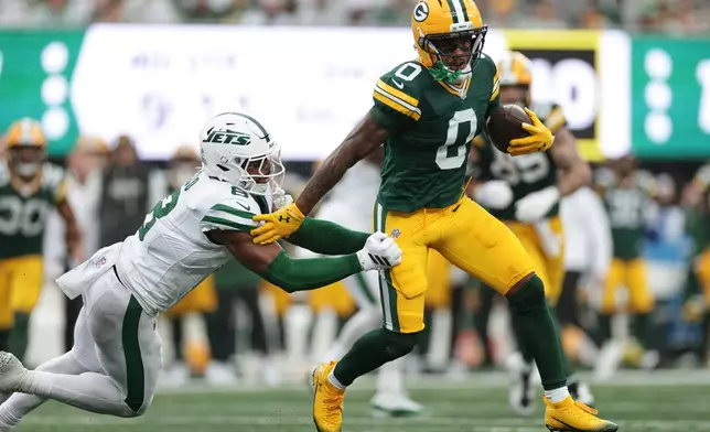 Green Bay Packers wide receiver Matthew Golden (0) runs the ball as New York Jets safety Andre Cisco (8) defends during an NFL football game in East Rutherford, N.J., Sunday, Sept. 20, 2026. (AP Photo/Adam Hunger)