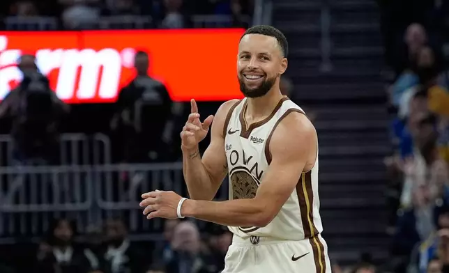FILE - Golden State Warriors guard Stephen Curry reacts after making a 3-point basket during the second half of an NBA basketball game against the Sacramento Kings, Tuesday, April 7, 2026, in San Francisco. (AP Photo/Godofredo A. Vásquez, File)