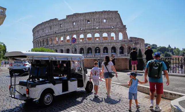 A golf cart sits near the Colosseum as tourists crowd the surrounding streets in Rome, Tuesday, Aug. 18, 2026, highlighting the growing presence of the vehicles in the capital’s historic center as authorities move to curb an industry blamed by critics for worsening congestion, illegal parking, and overtourism. (AP Photo/Gregorio Borgia)