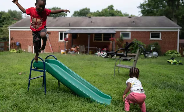 Khalidou Sy's children play in the backyard of the family's home in Lockland, Ohio, Friday, July 31, 2026. (AP Photo/Carolyn Kaster)