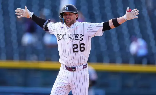 Colorado Rockies' Brett Sullivan celebrates after driving in the winning run with a walkoff single off Baltimore Orioles relief pitcher Grant Wolfram in the 11th inning of a baseball game Wednesday, Sept. 2, 2026, in Denver. (AP Photo/David Zalubowski)