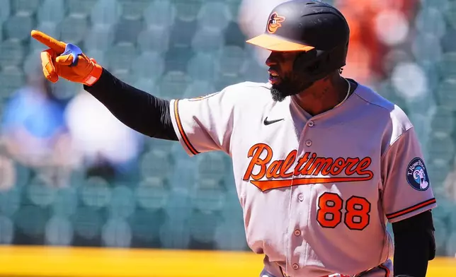 Baltimore Orioles' Luis Robert Jr. gestures to the dugout after hitting a two-run double off of Colorado Rockies starting pitcher Tomoyuki Sugano in the third inning of a baseball game Wednesday, Sept. 2, 2026, in Denver. (AP Photo/David Zalubowski)