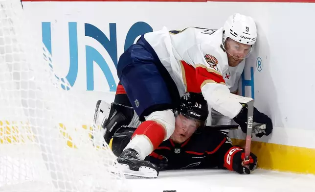 Florida Panthers' Sam Bennett (9) collides with Carolina Hurricanes' Jackson Blake (53) during the third period of an NHL hockey game in Raleigh, N.C., Tuesday, Sept. 29, 2026. (AP Photo/Karl DeBlaker)