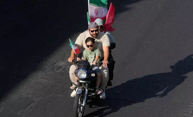 A family ride on a motorcycle during a state-organized motorcycle parade called "Janfada," meaning "Sacrifice for Iran,", in Tehran, Iran, Friday, Sept. 25, 2026. (AP Photo/Vahid Salemi)