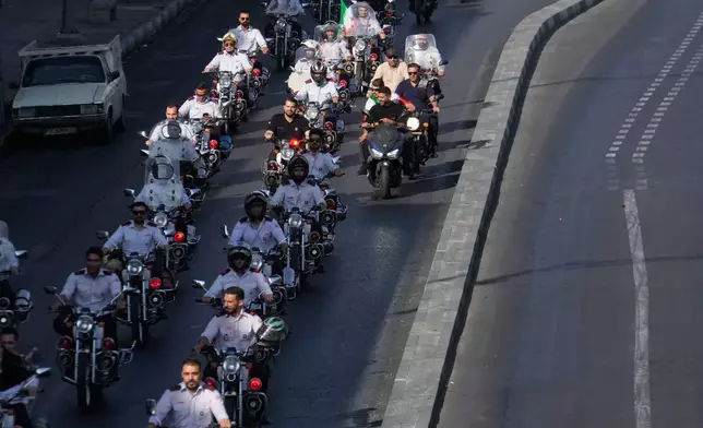 Firefighters ride motorcycles during a state-organized motorcycle parade called "Janfada," meaning "Sacrifice for Iran,", in Tehran, Iran, Friday, Sept. 25, 2026. (AP Photo/Vahid Salemi)