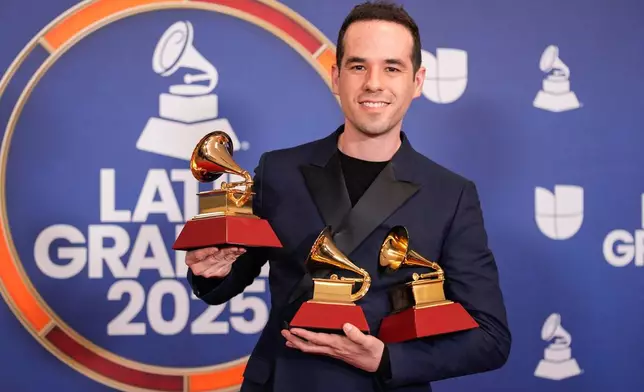FILE - Edgar Barrera, winner of the awards for best tropical song and song of the year for "Si Antes Te Hubiera Conocido," and award for songwriter of the year, poses in the press room during the 2025 Latin Grammys in Las Vegas on Nov. 13, 2025. (AP Photo/John Locher, File)