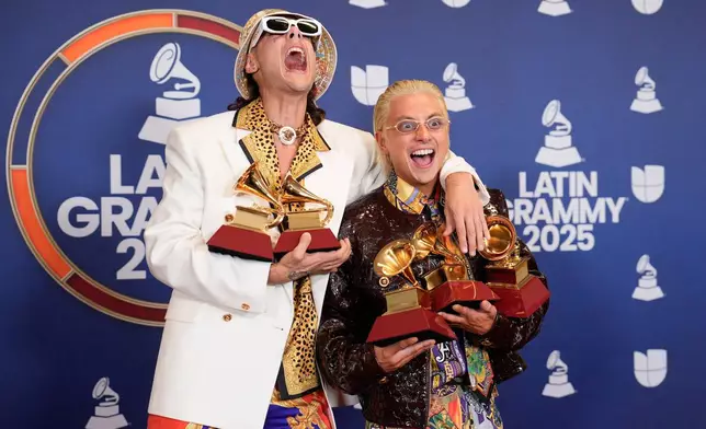 FILE - Ca7riel, left, and Paco Amoroso pose in the press room with the awards for best long and short form music video, best pop song , best alternative music video and best alternative song during the 2025 Latin Grammys on Nov. 13, 2025, in Las Vegas. (AP Photo/John Locher, File)