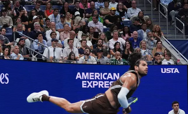 Fans watch as Carlos Alcaraz, of Spain, serves to Jaime Faria, of Portugal, during the second round of the U.S. Open tennis championships, Wednesday, Sept. 2, 2026, in New York. (AP Photo/Sydney Schaefer)