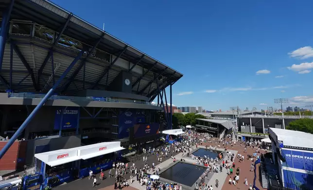 Fans walk outside Arthur Ashe Stadium at the U.S. Open tennis championships Wednesday, Aug. 26, 2026, in New York. (AP Photo/Frank Franklin II)