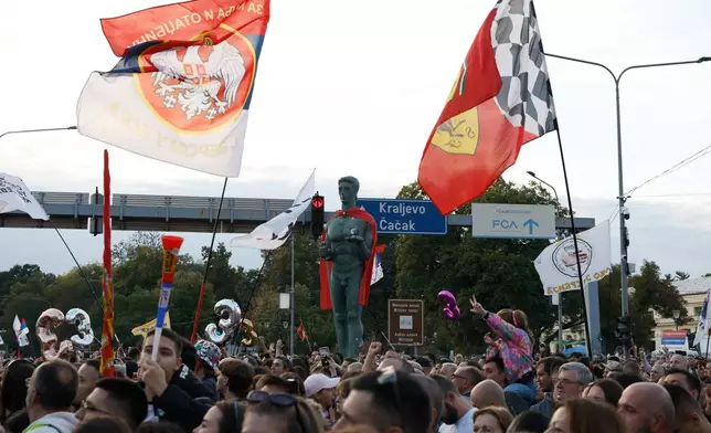 People welcome a group of university students at the end of their cycling tour of the Balkan country ahead of an early election next month challenging populist President Aleksandar Vucic, in Kragujevac, Serbia, Saturday, Sept. 26, 2026. (AP Photo/Marko Drobnjakovic)