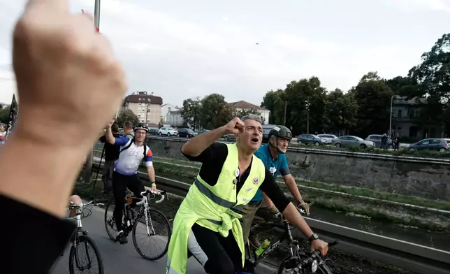 Ilija Srdanovic, cardiologist and professor at the Faculty of Medicine in Novi Sad, on top of the "Student list - Students win" in the upcoming parliamentary elections shouts slogans at the end of their cycling tour of the Balkan country, in Kragujevac, Serbia, Saturday, Sept. 26, 2026. (AP Photo/Marko Drobnjakovic)