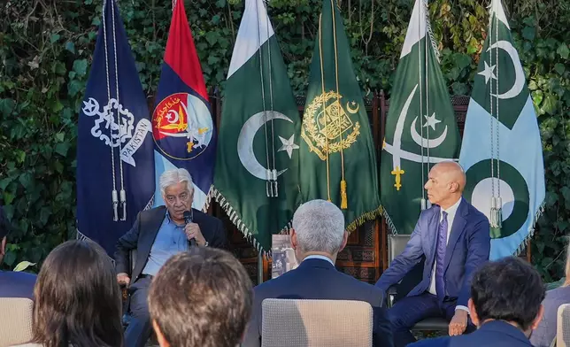 Pakistan's Defense Minister Khawaja Mohammad Asif, left, speaks with media at the Pakistani Embassy in Rome, Italy, Tuesday, Sept. 29, 2026. At right Pakistan's Ambassador to Italy Ali Javed looks on. (AP Photo/Andrea Rosa)