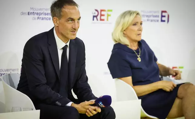 FILE - Co-president of French centre-left party, Place Publique Raphael Glucksmann and Far-right leader Marine Le Pen, candidates at presidential election attend a business meeting organized by the French business organization (MEDEF) in Paris, Thursday, Aug. 27, 2026. (AP Photo/Thomas Padilla, File)