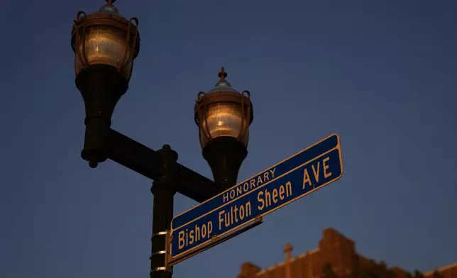 An honorary street sign for the late Archbishop Fulton Sheen stands just outside the Spalding Institute, the former high school Sheen attended, in Peoria, Ill., on July 14, 2026. (AP Photo/Jessie Wardarski)