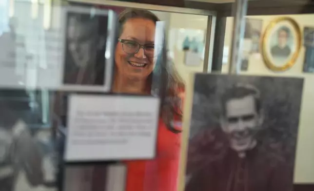 Bonnie Engstrom, who believes the late Archbishop Fulton Sheen helped save her son's life after he was born in 2010 without a pulse, looks at a photo of Sheen on display at the Sheen Museum in Peoria, Ill., on July 16, 2026. (AP Photo/Jessie Wardarski)