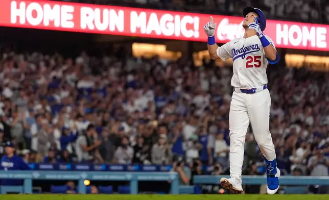 Los Angeles Dodgers' Tommy Edman gestures as he scores after hitting a solo home run during the sixth inning of a baseball game against the San Diego Padres, Tuesday, Sept. 22, 2026, in Los Angeles. (AP Photo/Mark J. Terrill)