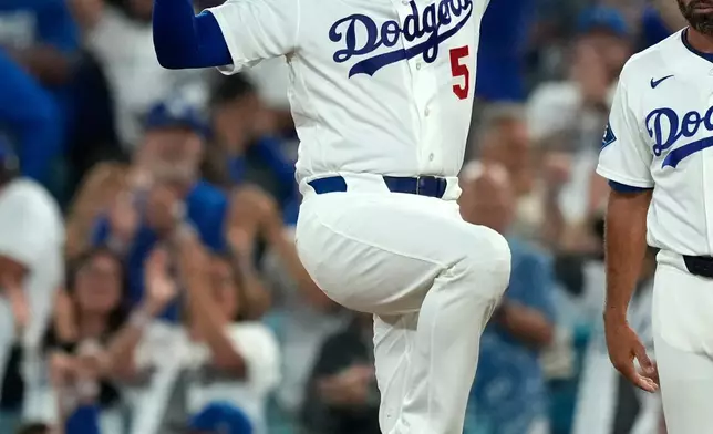 Los Angeles Dodgers' Freddie Freeman gestures after hitting an RBI single during the second inning of a baseball game against the San Diego Padres, Tuesday, Sept. 22, 2026, in Los Angeles. (AP Photo/Mark J. Terrill)