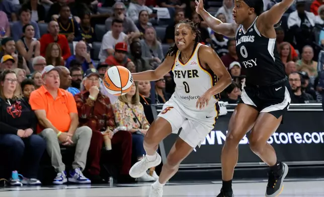 Indiana Fever guard Kelsey Mitchell, left, drives against Las Vegas Aces guard Jackie Young, right, during the first half in Game 1 of an WNBA basketball first-round playoff series Sunday, Sept. 27, 2026, in Las Vegas. (AP Photo/Steve Marcus)