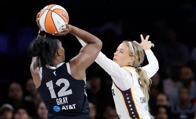 Indiana Fever guard Sophie Cunningham, right, defends against Las Vegas Aces guard Chelsea Gray (12) during the first half in Game 1 of an WNBA basketball first-round playoff series Sunday, Sept. 27, 2026, in Las Vegas. (AP Photo/Steve Marcus)