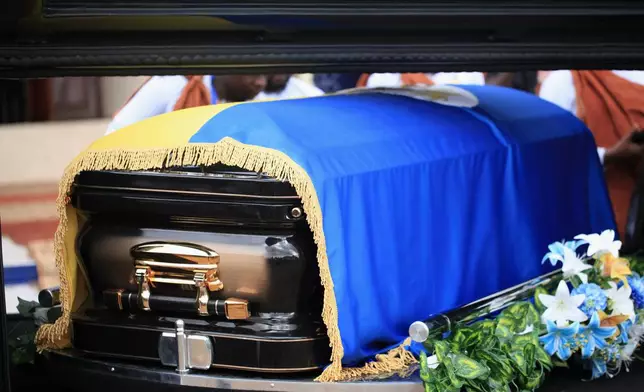 The casket of Tooro's King Oyo Nyimba is loaded into a hearse in the remote city of Fort Portal, near the Congo border in Uganda, Saturday, Sept. 12, 2026. (AP Photo/Patrick Onen)
