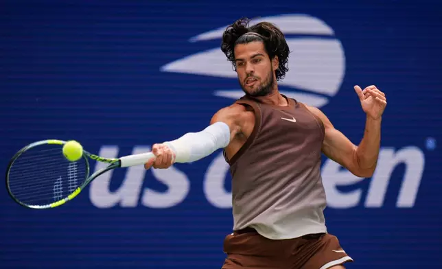 Carlos Alcaraz, of Spain, returns the ball to Roman Safiullin, of Russia, during the first round of the U.S. Open tennis championships, Monday, Aug. 31, 2026, in New York. (AP Photo/Seth Wenig)