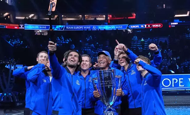 Team Europe's Carlos Alcaraz takes a selfie as team captain Yannick Noah holds the trophy celebrating with his team after they beat Team World to win the Laver Cup tennis tournament in London, Sunday, Sept. 27, 2026. (AP Photo/Maja Smiejkowska)