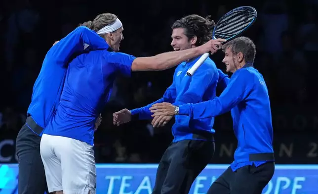 Team Europe celebrate after Alexander Zverev, in bandana, beat Team World's Learner Tien to clinch the Laver Cup tennis tournament in London, Sunday, Sept. 27, 2026. (AP Photo/Maja Smiejkowska)