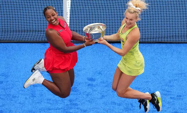 Taylor Townsend, of the United States, left, and Katerina Siniakova, of the Czech Republic, right, jump with their trophy after winning the women's doubles final of the U.S. Open tennis championships against Ashlyn Krueger, of the United States, and Robin Montgomery, of the United States, Friday, Sept. 11, 2026, in New York. (AP Photo/Kirsty Wigglesworth)