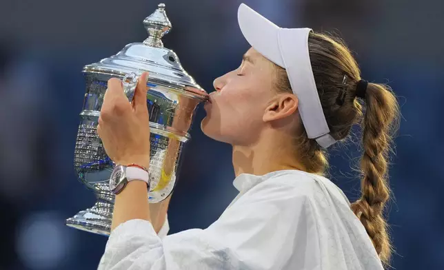 Elena Rybakina, of Kazakhstan, kisses the trophy after she won the women's singles final of the U.S. Open tennis championships against Aryna Sabalenka, of Belarus, Saturday, Sept. 12, 2026, in New York. (AP Photo/Kirsty Wigglesworth)
