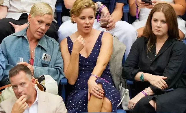 Pink, from left, Elizabeth Banks and Amy Adams attend a match between Aryna Sabalenka, of Belarus, and Elena Rybakina, of Kazakhstan, during the women's singles final of the U.S. Open tennis championships Saturday, Sept. 12, 2026, in New York. (AP Photo/Yuki Iwamura)