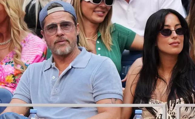Actor Brad Pitt, left, and Ines de Ramon attend a match between Aryna Sabalenka, of Belarus, and Elena Rybakina, of Kazakhstan, during the women's singles final of the U.S. Open tennis championships Saturday, Sept. 12, 2026, in New York. (AP Photo/Kirsty Wigglesworth)
