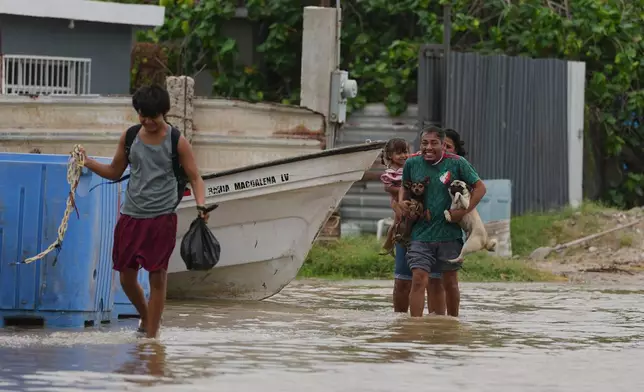 People evacuate their homes as Hurricane Polo approaches Puerto San Carlos, Baja California Sur state, Mexico, Monday, Sept. 28, 2026. (AP Photo/Eduardo Verdugo)