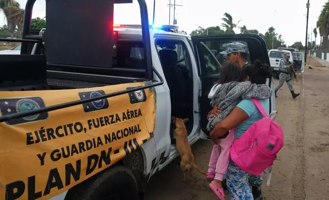 Residents are evacuated by the Army as Hurricane Polo approaches Puerto San Carlos, Baja California Sur state, Mexico, Monday, Sept. 28, 2026. (AP Photo/Eduardo Verdugo)