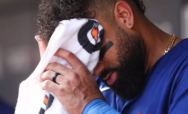 Texas Rangers third baseman Ezequiel Duran wipes his face with a towel during the first inning of a baseball game against the Minnesota Twins, Sunday, Sept. 27, 2026, in Minneapolis. (AP Photo/Matt Krohn)
