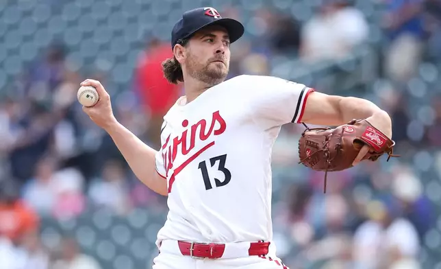 Minnesota Twins starting pitcher Dean Kremer delivers a pitch against the Texas Rangers during the first inning of a baseball game, Sunday, Sept. 27, 2026, in Minneapolis. (AP Photo/Matt Krohn)