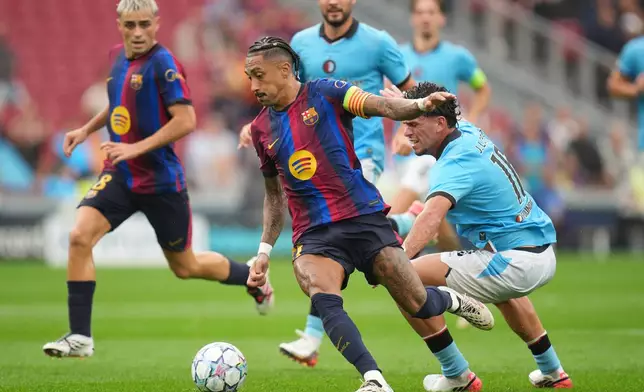 Feyenoord's Javi Lopez, right, tries to stop Barcelona's Raphinha during the Champions League opening phase soccer between Barcelona and Feyenoord in Barcelona, Spain, Wednesday, Sept. 9, 2026.(AP Photo/Emilio Morenatti)